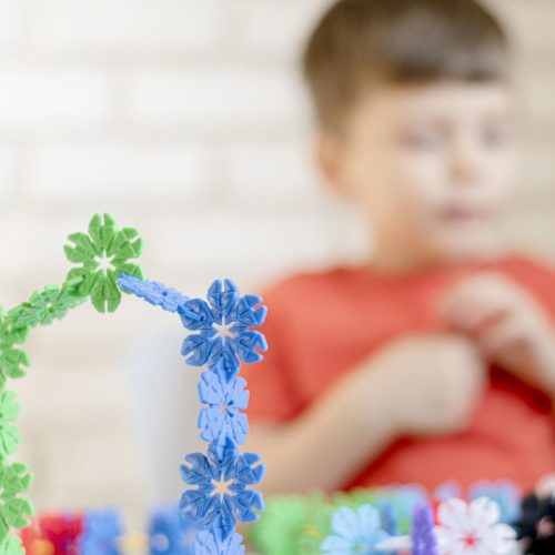 blurred-kid-with-floral-toy