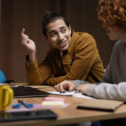 two-teenage-boys-studying-together-home-with-laptop